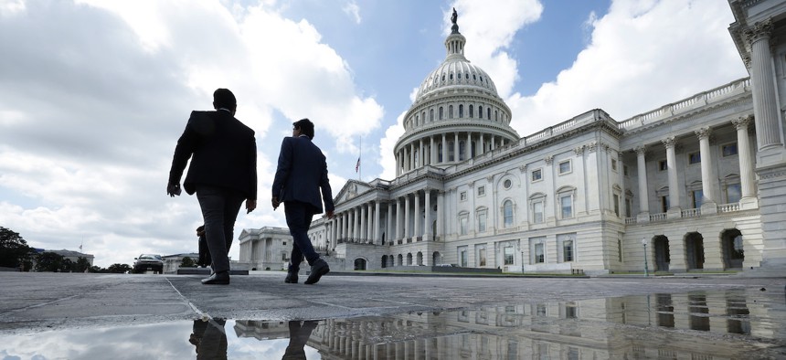 Visitors walk past the U.S. Capitol on Sept.11, 2023. Congressional leaders have only a few weeks to broker a deal to keep agencies from shuttering their doors.