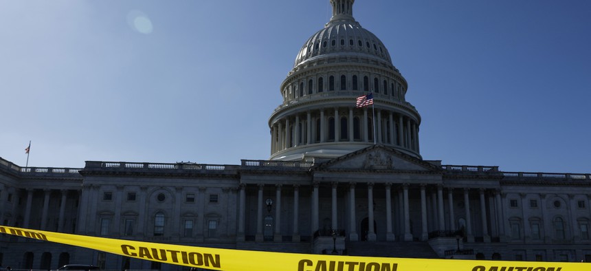 Caution tape blows in the wind on the east front plaza of the U.S. Capitol Building on Sept. 27, 2023. House Speaker Kevin McCarthy, R-Calif., continues to have difficulty finding a legislative path that would prevent the federal government from partially shutting down at midnight on Sept. 30 and would also not jeopardize his speakership. 