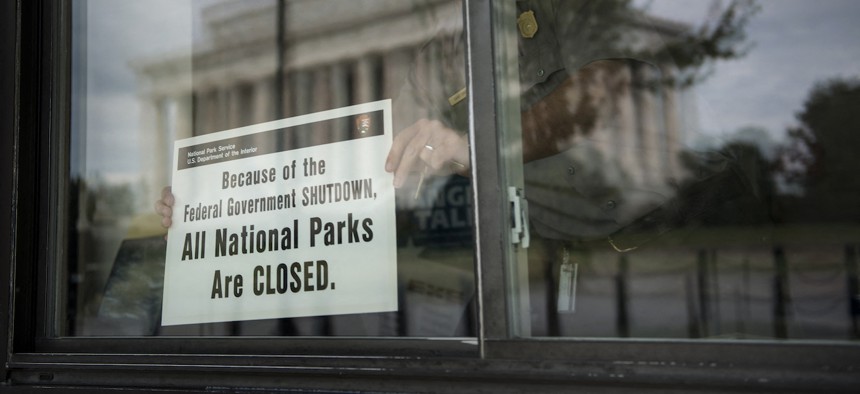 A U.S. Park Ranger places a closed sign inside an information booth at the Lincoln Memorial on the National Mall on Oct. 1, 2013. The federal government is in the countdown to another shutdown, as lawmakers haggle over spending bills. 