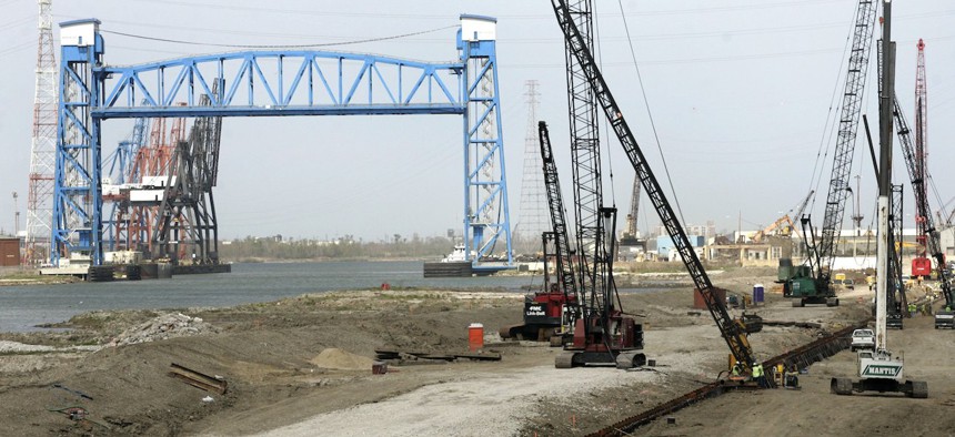Construction crews drive 80-foot H-pilings into the ground as they continue to rebuild the levee system along the breached levee in the Ninth Ward of New Orleans on March 8, 2006. Criticism surrounded the rebuilding of New Orleans’ levees, with the building materials used by the Army Corps of Engineers being particularly faulted by an independent panel of experts charged with overseeing the reconstruction.  