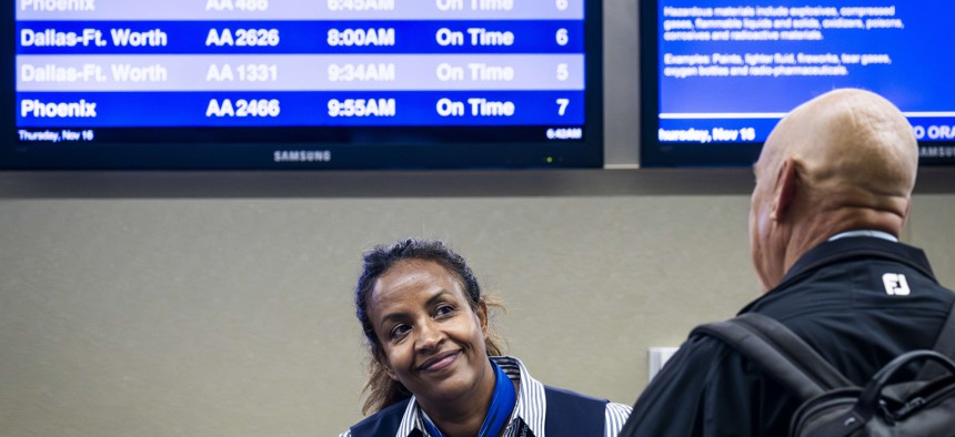An American Airlines agent helps a passenger at John Wayne Airport in Santa Ana, California last week.
