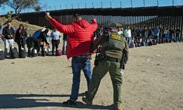 Migrants attempting to cross in to the U.S. from Mexico are detained by U.S. Customs and Border Protection at the border Nov. 28, 2023 in Jacumba Hot Springs, California.
