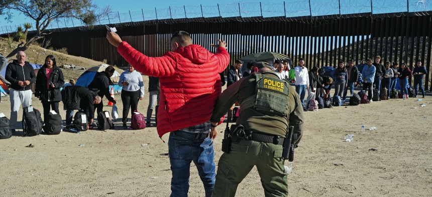 Migrants attempting to cross in to the U.S. from Mexico are detained by U.S. Customs and Border Protection at the border Nov. 28, 2023 in Jacumba Hot Springs, California.
