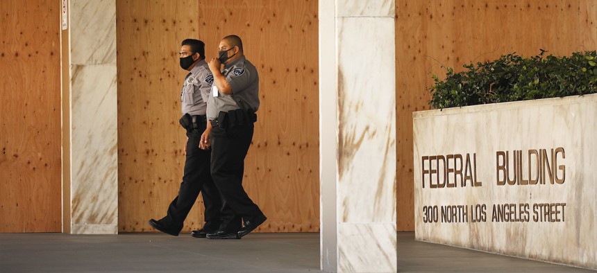 Security officers outside field offices of the U.S. Citizenship and Immigration Services in Los Angeles on July 27, 2020.