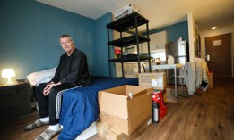 Marine veteran Rich Aloia sits on his bed in his apartment at the newly-opened Tunnel to Towers Veterans Village on Nov. 21, 2023 in Tomball, Texas.