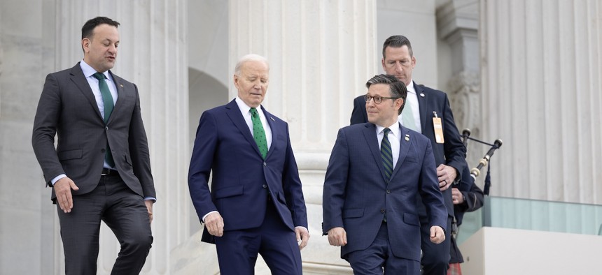 President Biden (second from the left) and House Speaker Mike Johnson, R-La.,  (third from left) walk down the east steps of the Capitol on March 15, 2023. Biden has thrown his support behind the new funding deal appropriators have worked out. 