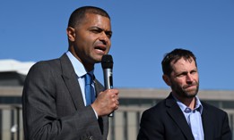 VA Under Secretary for Health Shereef Elnahal, left, with Rep. Jason Crow, D-Colo., right, speaks during a press conference on March 4, 2024. Elnahal said this week that the department would use attrition to reduce staff. 