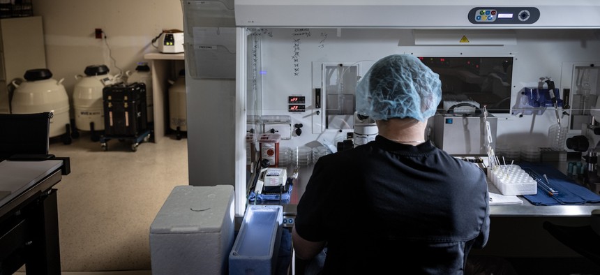 An embryologist works on freezing embryos at West Coast Fertility Centers, in Fountain Valley, California.