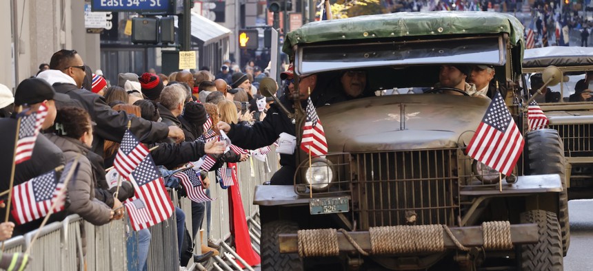 Veterans in a vintage jeep hand out Wounded Warriors flags during the annual Veterans Day Parade along Fifth Avenue on Nov. 11, 2023, in New York City. 