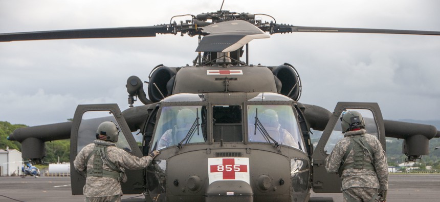 Soldiers from the Hawaii Army National Guard preparing an HH-60 Black Hawk utility helicopter for flight as part of rescue operations in 2018.