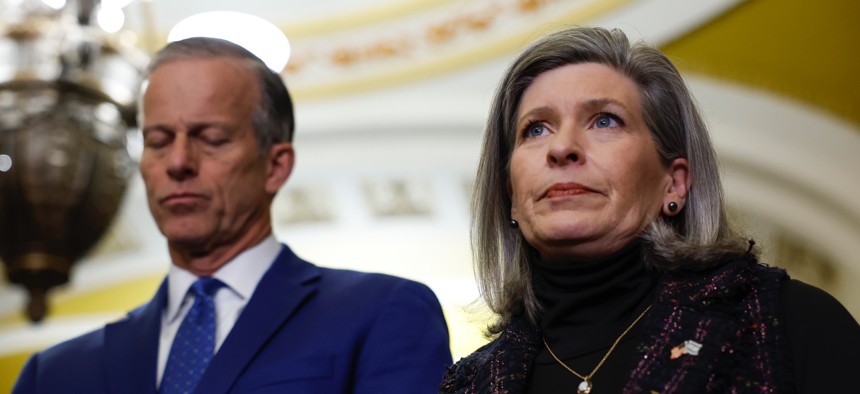 Sens. John Thune, R-S.D., and Joni Ernst, R-Iowa, listen during a news conference after a weekly policy luncheon with Senate Republicans at the U.S. Capitol on Feb. 06, 2024. Ernst is calling for a SBA OIG investigation of the agency's in-office utilization rates.  