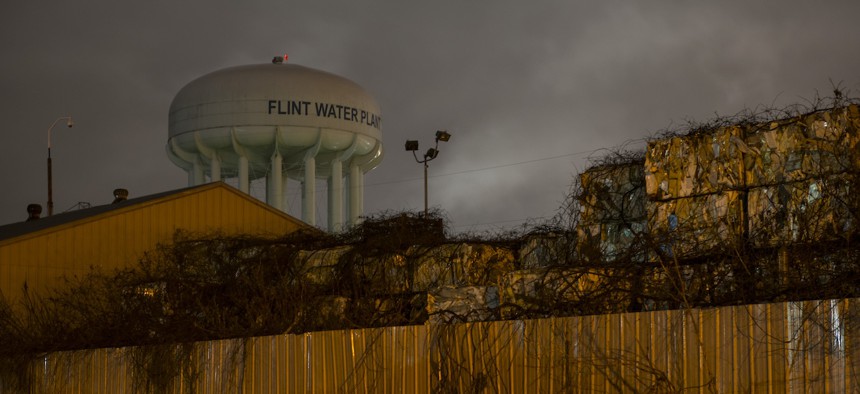 The Flint City Water Plant water tower is seen from behind a metals recycling facility on Dec. 20, 2018.