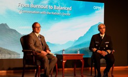OPM acting Director David Shriver, left, and U.S. Surgeon General Vivek Murthy, right, discuss burnout among federal employees at an OPM event on May 9.