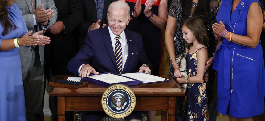 U.S. President Joe Biden signs the PACT Act in the East Room of the White House August 10, 2022.