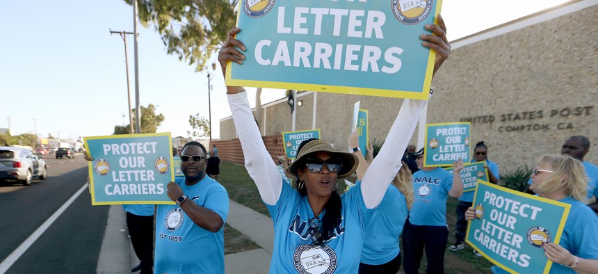 U.S. Postal Service letter carriers rally at the USPS Compton Main Office on Oct. 4, 2023, to call attention robberies and physical assaults experienced by letter carriers locally and across the nation. A GAO report found USPS officials lack formal procedures for determining how many law enforcement personnel it needs.  