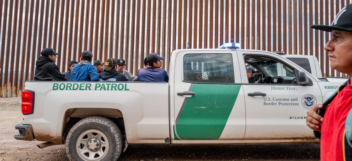 Migrants seeking asylum from Central and South America sit in the back of a border patrol vehicle after being apprehended by U.S. Customs and Border protection officers after illegally crossing over into the U.S. on June 24, 2024 in Ruby, Ariz.