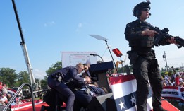 Secret Service agents cover former president Donald Trump during a campaign rally on Saturday, July 13, 2024 in Butler, Pa. Members of Congress have criticized the protective agency for letting a gunman get within striking distance.