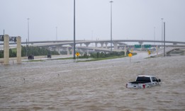 A vehicle is left abandoned in floodwater on a highway after Hurricane Beryl swept through the area on July 8, in Houston, Texas. 