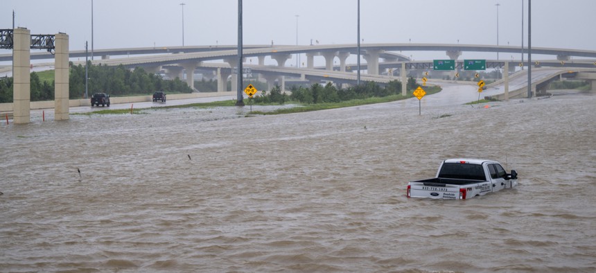 A vehicle is left abandoned in floodwater on a highway after Hurricane Beryl swept through the area on July 8, in Houston, Texas. 