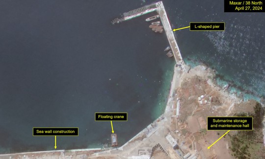 Construction activity on coastal seawall and submarine storage and maintenance hall near L-shaped pier on imagery from April 27, 2024