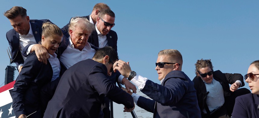  Republican presidential candidate former President Donald Trump is rushed offstage by U.S. Secret Service agents after being grazed by a bullet during a rally on July 13, 2024 in Butler, Pennsylvania.