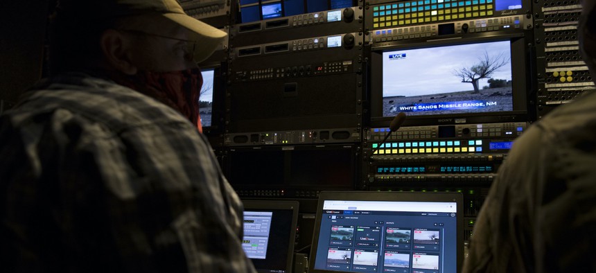 In this 2020 photo, Jason Davis, a cyber technician from the 2nd Audiovisual Squadron, monitors the live feed inside a production truck during a JADC2 experiment at Joint Base Andrews, Maryland.