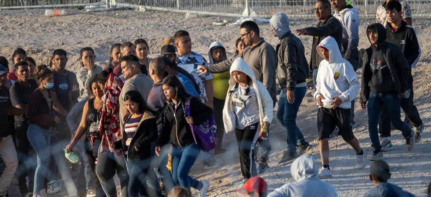 Unaccompanied minors walk towards U.S. Border Patrol vehicles after crossing over from Mexico on May 09, 2023 in El Paso, Texas.