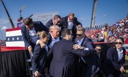 U.S. Secret Service agents remove Donald Trump from the stage with blood on his face following an assassination attempt during a campaign rally in Butler, Penn., on July 13. The incident prompted GAO to add increased Secret Service training to its list of priority recommendations. 