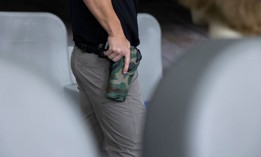 A federal air marshal service instructor prepares to draw his gun for a demonstration at a shooting range at the TSA training center in Atlantic City, N.J., on Nov. 7, 2023. The marshals are always on call and often have to work in 20-hour shifts.