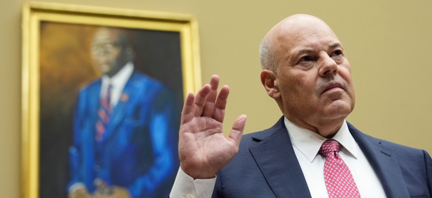 Postmaster General Louis DeJoy, pictured here at May 2023 House Oversight hearing, told lawmakers Thursday that the USPS would ensure timely delivery of mail-in ballots amid paused reform efforts. 