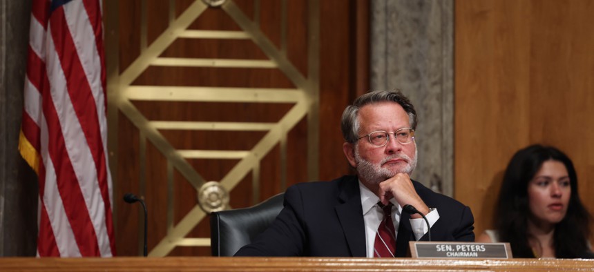 Sen. Gary Peters, D-Mich., listens during a congressional hearing on July 21, 2022. Peters criticized the Federal Acquisition Regulatory Council for delaying implementation of legislation he sponsored regarding contractor conflicts of interest that was signed into law in 2022.