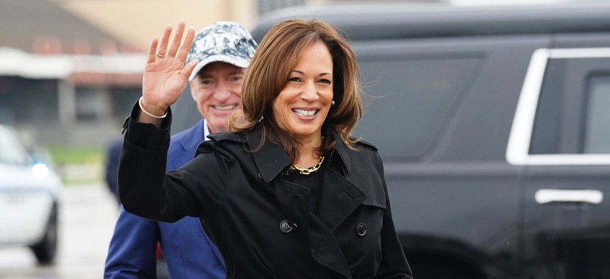 Democratic presidential nominee and US Vice President Kamala Harris waves after being greeted by Sen. Mark Kelly, D-Ariz., as she departs for the US-Mexico border from Joint Base Andrews in Maryland, Sept. 27, 2024. 