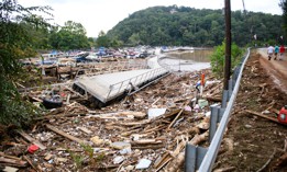 The Rocky Broad River flows into Lake Lure and overflows the town with debris from Chimney Rock, North Carolina after heavy rains from Hurricane Helene on Sept. 28, 2024, in Lake Lure, North Carolina.