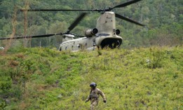 A member of the Maryland National Guard descends a hill at a supply drop point in the aftermath of Hurricane Helene on October 1, near Bat Cave, North Carolina.