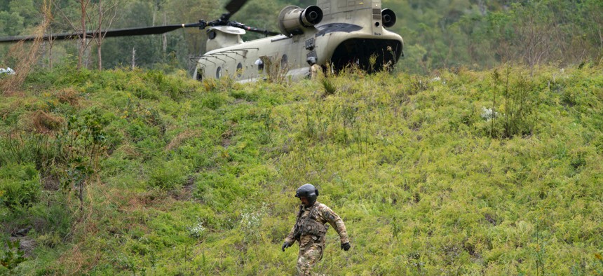 A member of the Maryland National Guard descends a hill at a supply drop point in the aftermath of Hurricane Helene on October 1, near Bat Cave, North Carolina.