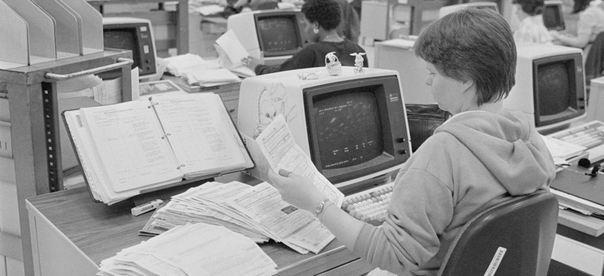 IRS workers process tax forms at Philadelphia's northeast IRS Service Center in 1986. The tax agency is still reliant on IT systems dating back 50 years and more.