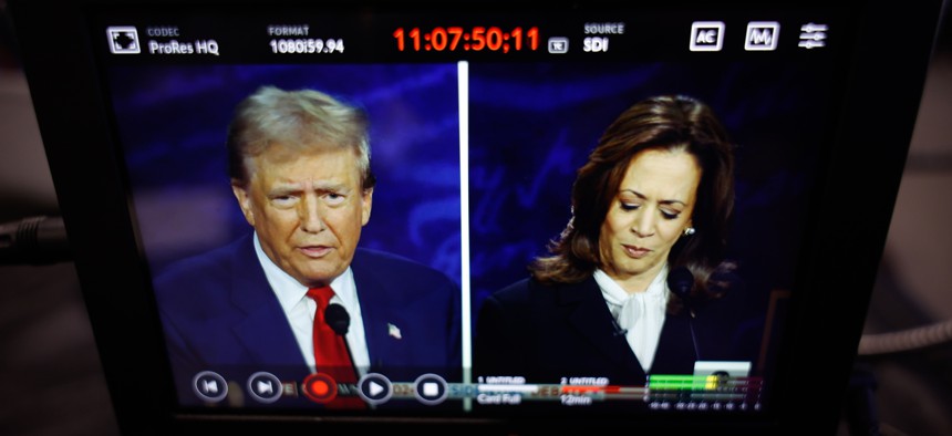 Republican presidential nominee, former President Donald Trump, and Democratic presidential nominee, Vice President Kamala Harris, are seen on a screen as they debate during the presidential election campaign at The National Constitution Center on September 10.