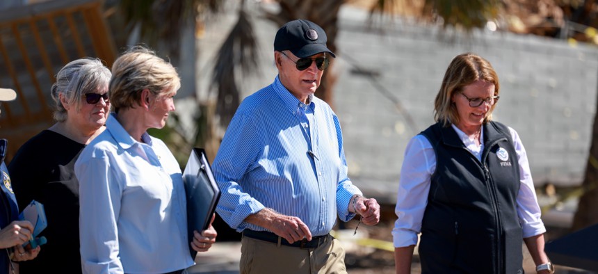 President Joe Biden walks with Deanne Criswell, right, administrator of the Federal Emergency Management Agency, after a tour of the damage caused by Hurricane Milton on Oct. 13, 2024 in St Pete Beach, Florida.