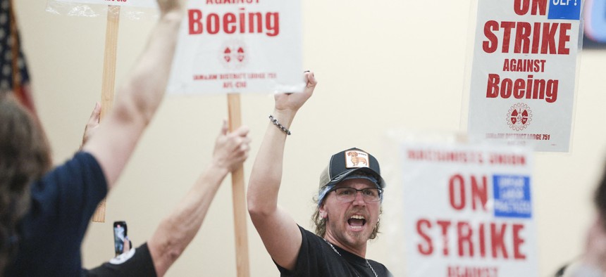 Union members react as Aerospace Machinists District 751 President Jon Holden (out of frame) announces that union members rejected a proposed Boeing contract and will go on strike, following voting results at their union hall in Seattle, Washington, on September 12, 2024.