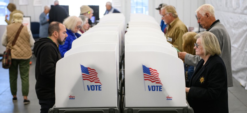 Voters make selections at their voting booths inside an early voting site on Oct. 17, 2024 in Hendersonville, North Carolina.