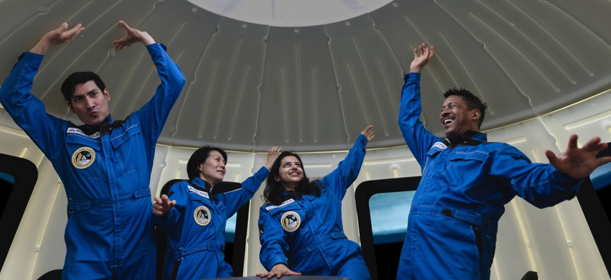 Four commercial space travelers experiencing weightlessness.