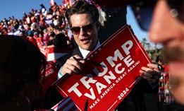 Rep. Matt Gaetz, R-Fla., prepares to sign a Trump-Vance sign at a campaign rally for former President Donald Trump on Oct. 12, 2024, in Coachella, Calif. Trump has picked Gaetz to lead the Justice Department. 