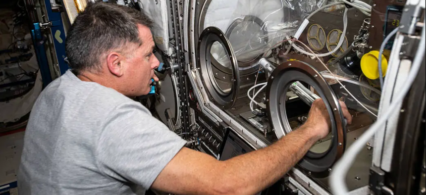 May 21, 2021) — NASA astronaut and Expedition 65 Flight Engineer Shane Kimbrough swaps samples inside the Microgravity Science Glovebox for an experiment called Solidification Using a Baffle in Sealed Ampoules, or SUBSA. The physics investigation explores experimental methods of crystallizing melts in microgravity and is expected to result in reduced fluid motion in the melt, leading to better distribution of subcomponents and the potential for improved technology used in producing semiconductor crystals.