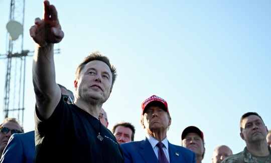 BROWNSVILLE, TEXAS - NOVEMBER 19: Elon Musk speaks with U.S. President-elect Donald Trump and guests at a viewing of the launch of the sixth test flight of the SpaceX Starship rocket on November 19, 2024 in Brownsville, Texas. SpaceX’s billionaire owner, Elon Musk, a Trump confidante, has been tapped to lead the new Department of Government Efficiency alongside former presidential candidate Vivek Ramaswamy.