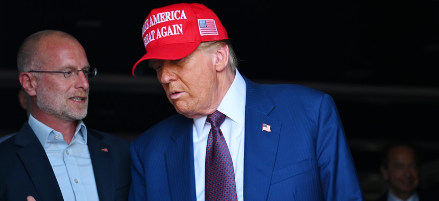 Incoming Federal Communications Commission Chair Brendan Carr, left, speaks with President-elect Donald Trump at an event earlier this month in Texas.