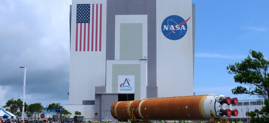 CAPE CANAVERAL, FLORIDA, UNITED STATES - JULY 24: Workers transport the 212-foot-tall SLS core stage for the Artemis II moon rocket from the Pegasus barge (not shown) to the nearby Vehicle Assembly Building at NASA's Kennedy Space Center on July 24, 2024 in Cape Canaveral, Florida.