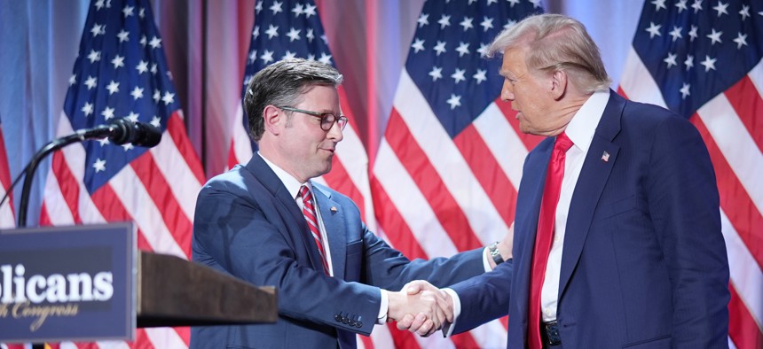 Speaker of the House Mike Johnson, R-La., shakes hands with President-elect Donald Trump onstage at a House Republicans Conference meeting at the Hyatt Regency on Capitol Hill on Nov. 13, 2024 in Washington, D.C.