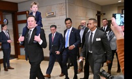 Tesla CEO Elon Musk, co-chair of the non-governmental Department of Government Efficiency, carries his son X on his shoulders, as he walks with Speaker of the House Mike Johnson (second from left) and Vivek Ramaswamy (center), before a meeting with members of Congress at the Capitol on Dec. 5, 2024.