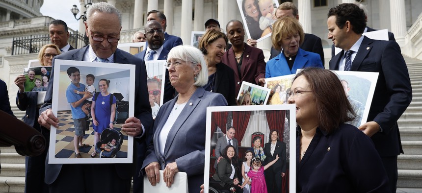 Sen. Tammy Duckworth, D-Ill., (far right) speaks about access to in vitro fertilization on the steps of the Capitol building on Sept. 17, 2024. 