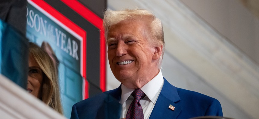 President-elect Donald Trump rings the opening bell on the trading floor of the New York Stock Exchange on Dec. 12, 2024. Trump said Monday that he was exploring the potential of privatizing the U.S. Postal Service. 